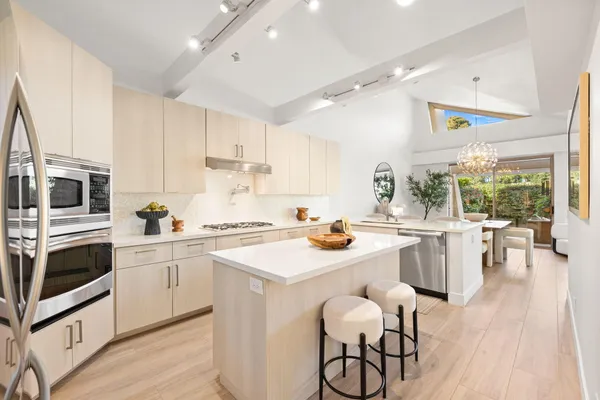 a kitchen with a sink and a stove top oven