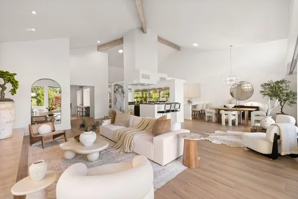 a living room with fireplace furniture and a wooden floor