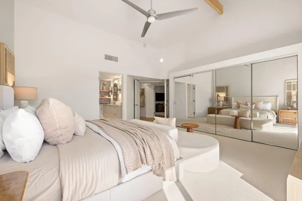 a bedroom with a large bed and a large window