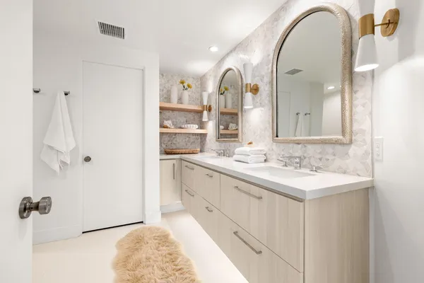 a bed room with a bed mirror and a window