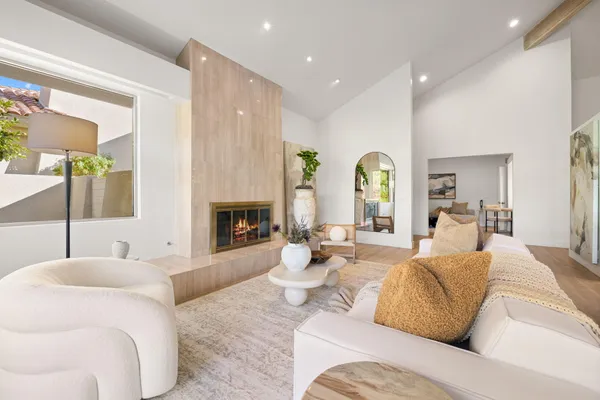 a living room with furniture a fireplace and a table