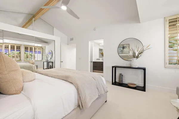 a view of a patio with table and chairs under an umbrella
