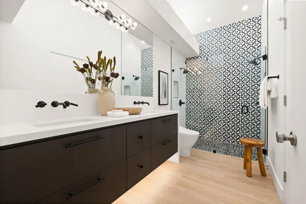 a view of a patio with couches and a fire pit and wooden fence