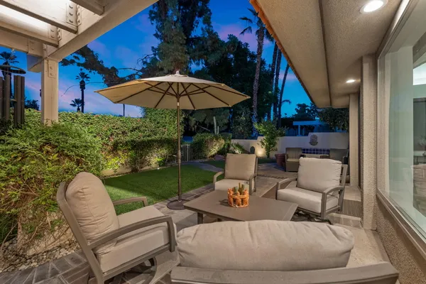 an aerial view of multiple houses with a yard