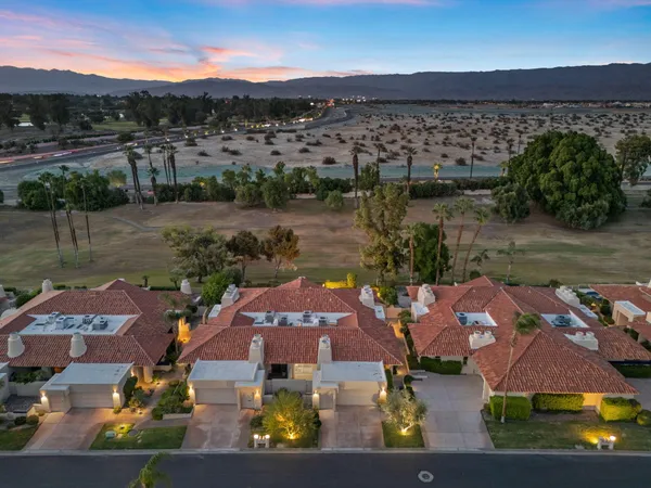 a view of a house with backyard porch and sitting area