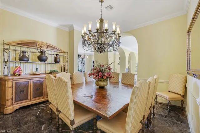 a view of a dining room with furniture and chandelier