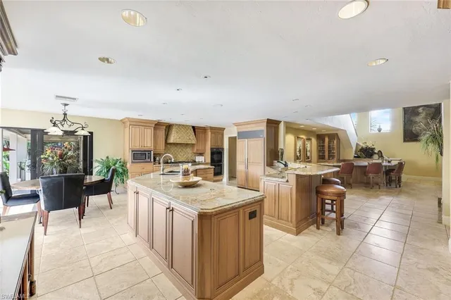 a open kitchen with cabinets a sink and stainless steel appliances
