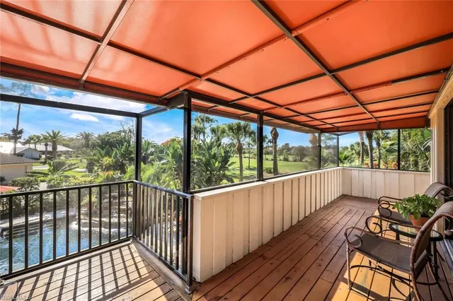 a view of a chair and tables in the balcony