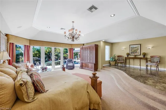 a bed room with a bed and a chandelier