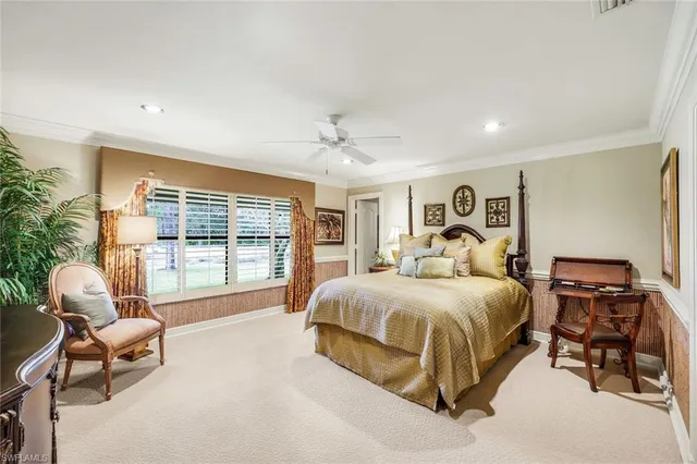 a spacious bedroom with a bed and a couch