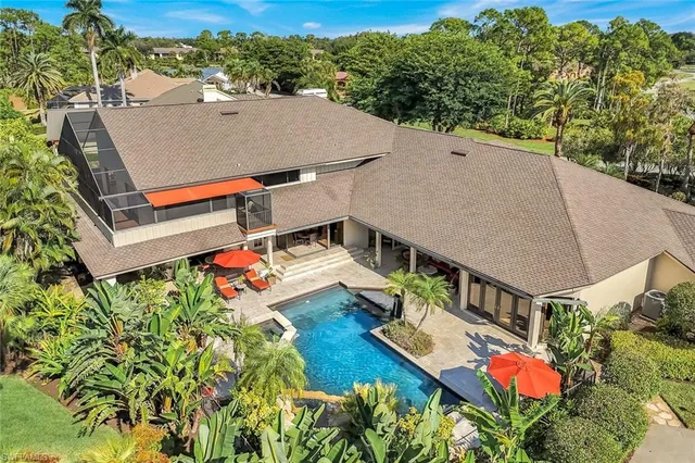 an aerial view of a house with pool