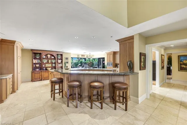 a dining hall with stainless steel appliances a table and chairs in it