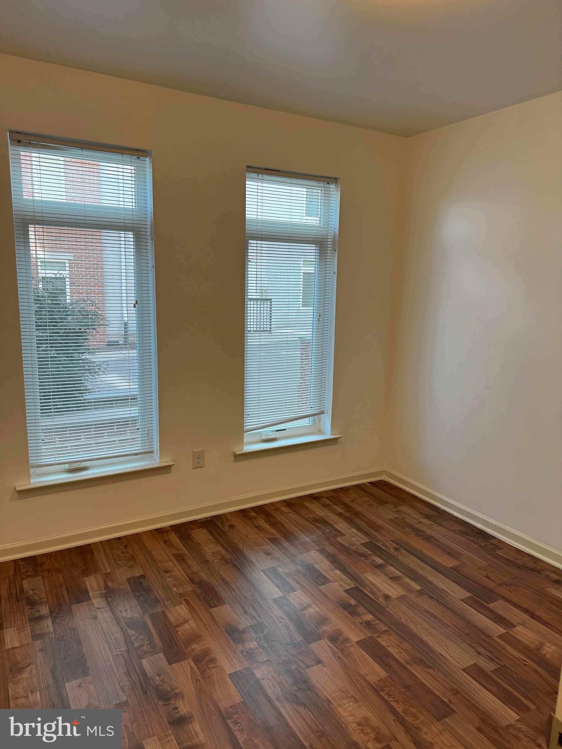 6619 Ridge Avenue, Unit 204 Philadelphia, PA 19128 - Photo 6 of 8 a view of an empty room with wooden floor and a window