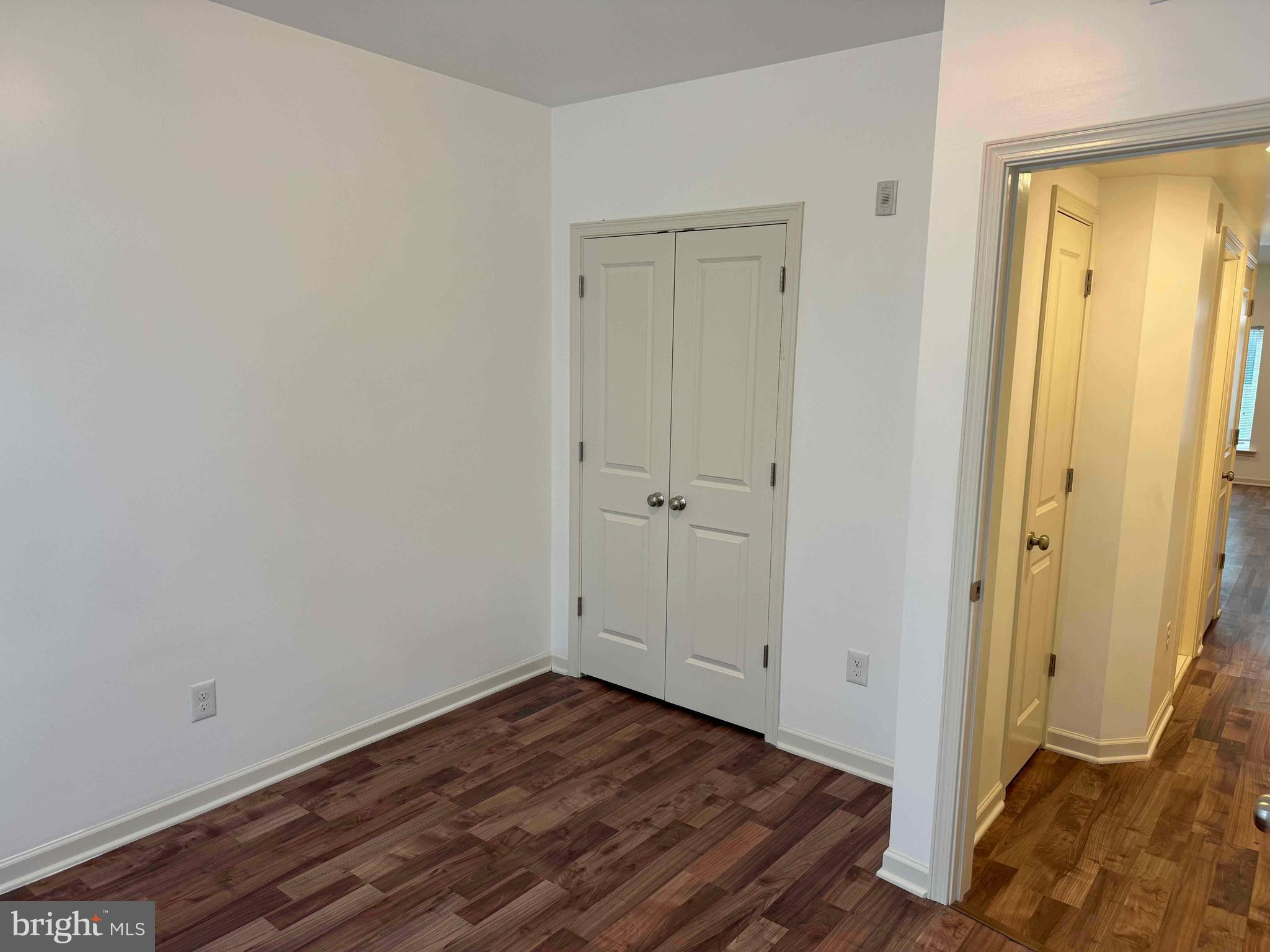 6619 Ridge Avenue, Unit 204 Philadelphia, PA 19128 - Photo 7 of 8 an empty room with wooden floor and closet