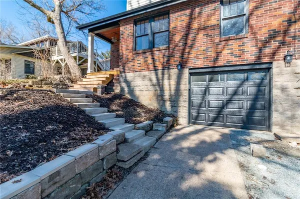 a view of a house with a wooden fence