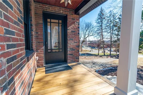 a view of a door of a house with a porch