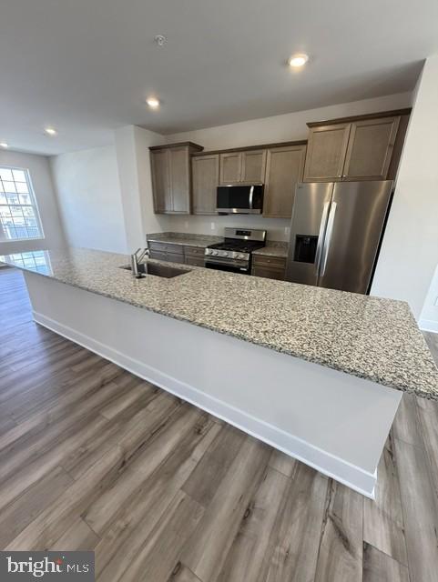 7608 River Reach Road Baltimore, MD 21244 - Photo 4 of 14 a large kitchen with stainless steel appliances a large counter top a stove and a sink