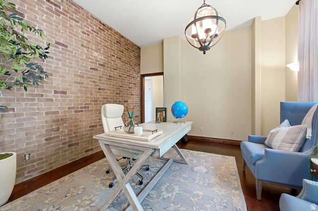 335 Bern Way Midway, UT 84049 - Photo 10 of 88 Exposed brick accent wall, dark wood-finish flooring, recessed wall niche, contemporary chandelier, and a wide entryway
