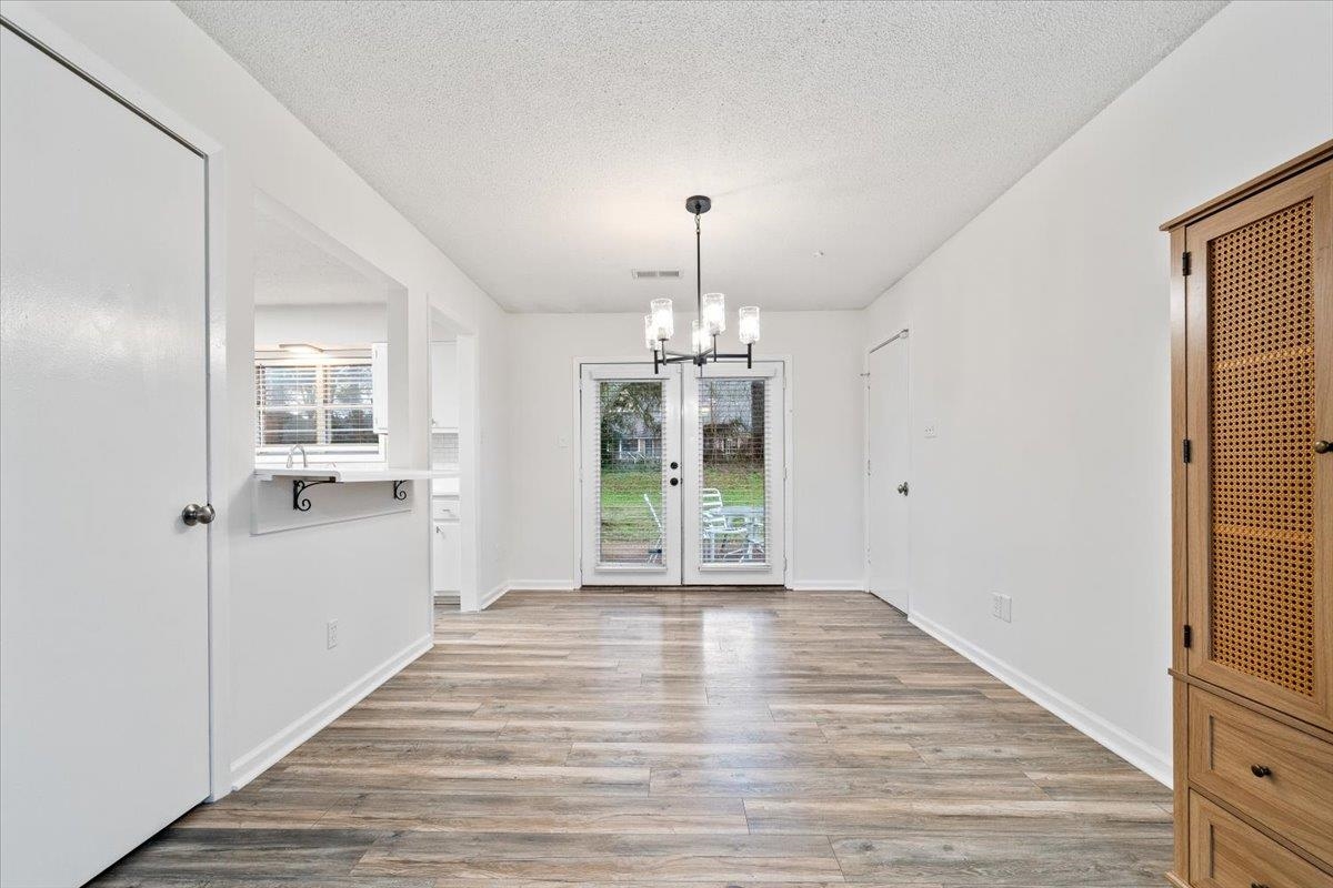 947 Hunters Retreat Drive Collierville, TN 38017 - Photo 4 of 24 a view of a hallway with wooden floor and a kitchen