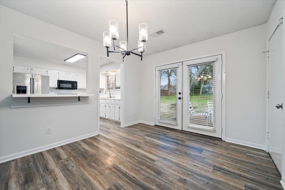 947 Hunters Retreat Drive Collierville, TN 38017 - Photo 5 of 24 a view of a kitchen with wooden floor and a ceiling fan