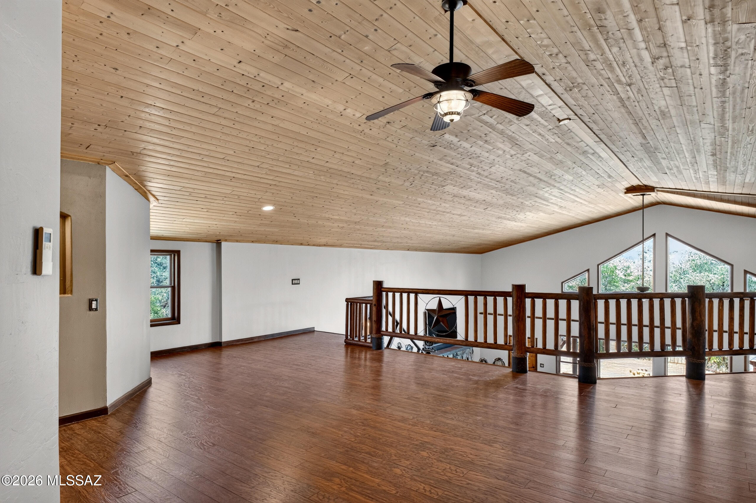 531 South Cody Loop Road Oracle, AZ 85623 - Photo 20 of 38 a view of an empty room with wooden floor