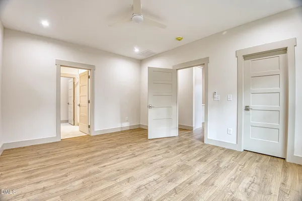 a bedroom with a large bed and a rug