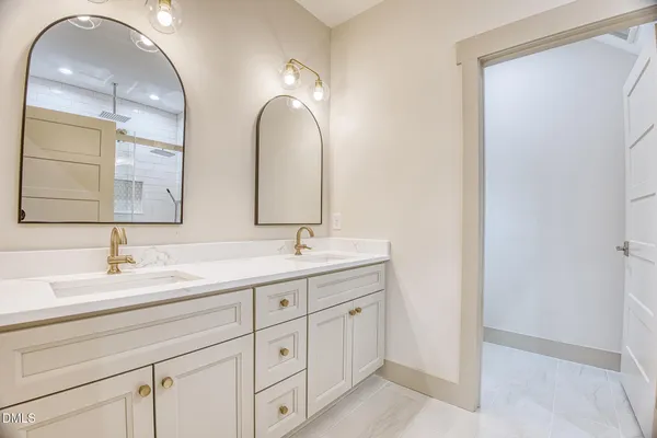 a bedroom with a bed and a large mirror