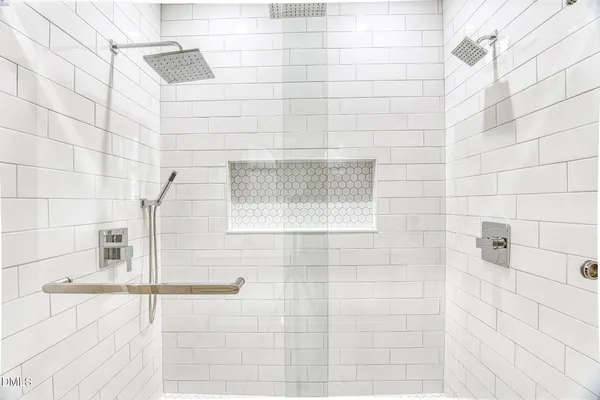 a bathroom with a double vanity sink and a mirror