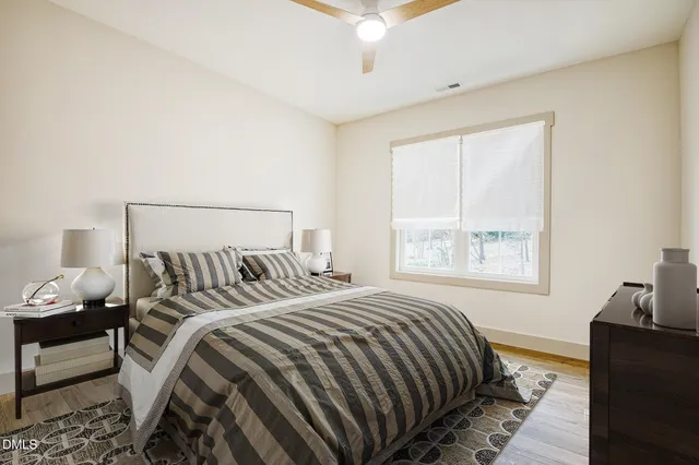 a bathroom with a granite countertop sink toilet mirror and bathtub