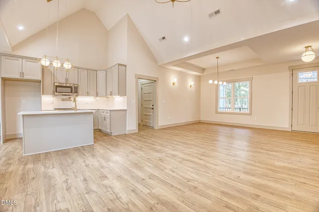 a view of kitchen with wooden floor and electronic appliances