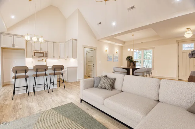 a living room with furniture and kitchen view