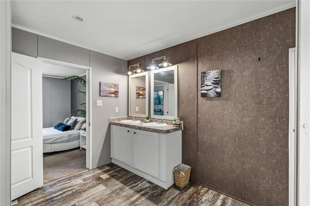 429 Gibson Road Anderson, SC 29625 - Photo 26 of 47 Textured walls and resilient vinyl plank flooring elevate this modern vanity area.