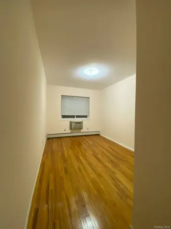 a view of an empty room and wooden floor