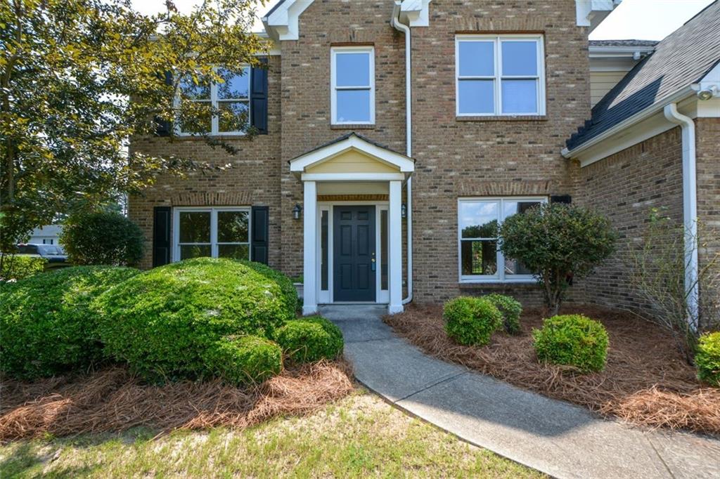 3420 Bulloch Lake Road Loganville, GA 30052 - Photo 4 of 57 a front view of a house with garden