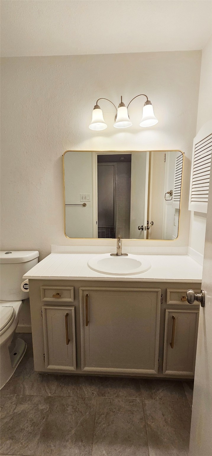 11550 Chimney Rock Road, Unit 205 Houston, TX 77035 - Photo 15 of 27 Clean, classic bathroom with tiled shower-tub combo, single vanity, and updated lighting.