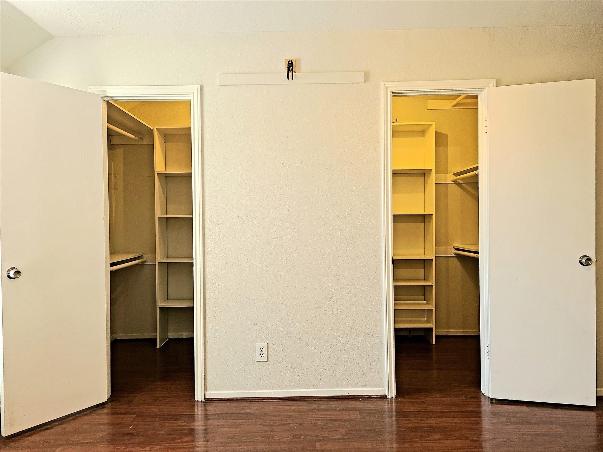 11550 Chimney Rock Road, Unit 205 Houston, TX 77035 - Photo 18 of 27 rimary bedroom features dual walk-in closets with built-in shelving—ample space for clothing and storage.