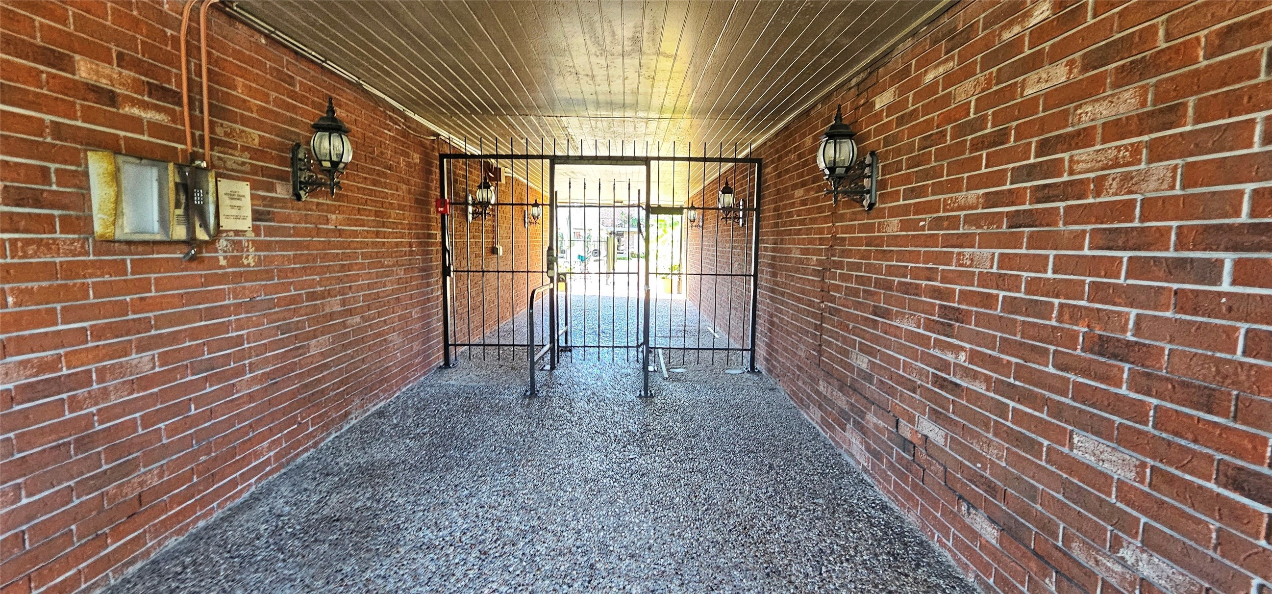 11550 Chimney Rock Road, Unit 205 Houston, TX 77035 - Photo 3 of 27 a view of a pathway with a brick wall