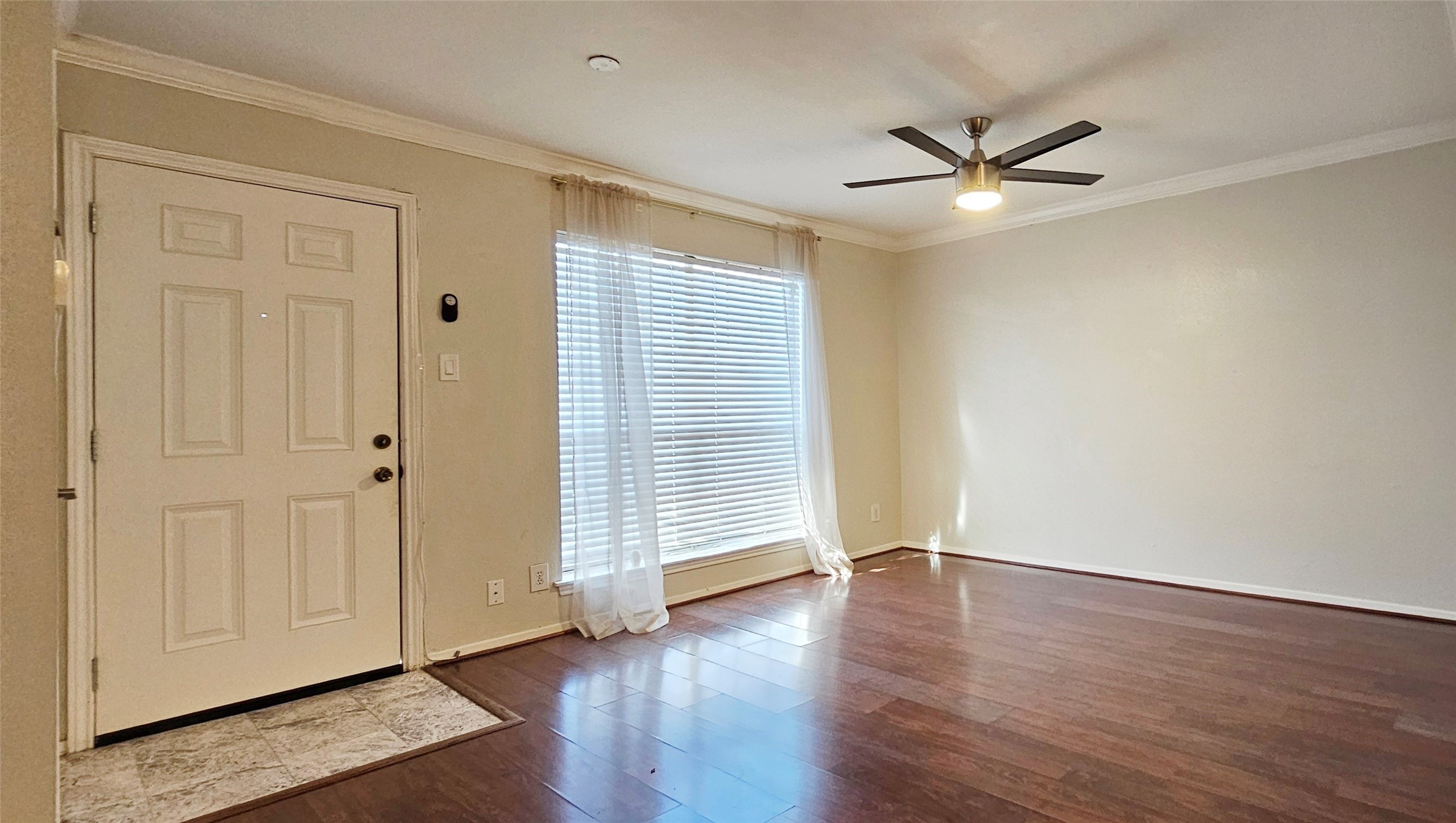 11550 Chimney Rock Road, Unit 205 Houston, TX 77035 - Photo 5 of 27 Private front entry with tile landing and windowed door, leading into a well-lit living space.