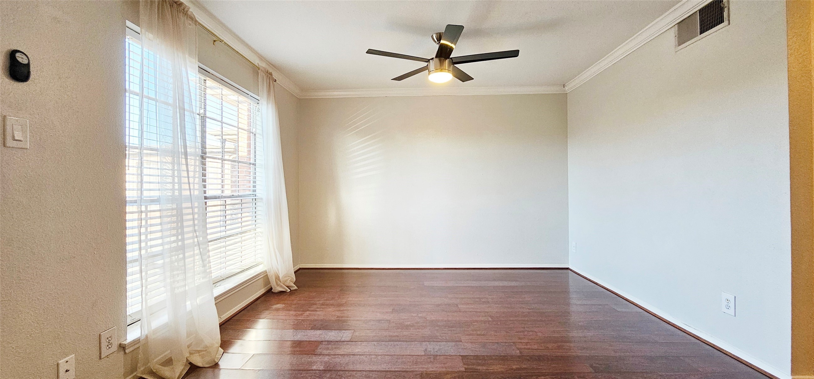 11550 Chimney Rock Road, Unit 205 Houston, TX 77035 - Photo 7 of 27 a view of empty room with wooden floor and fan