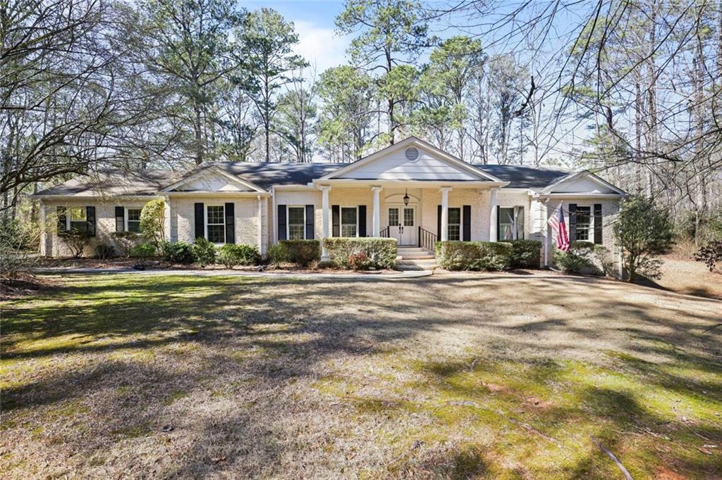 4505 Cochran Mill Road Fairburn, GA 30213 - Photo 1 of 36 a front view of a house with a yard