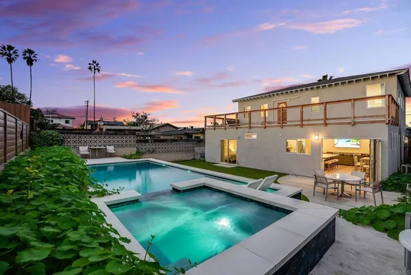 a view of a swimming pool with a table and chairs