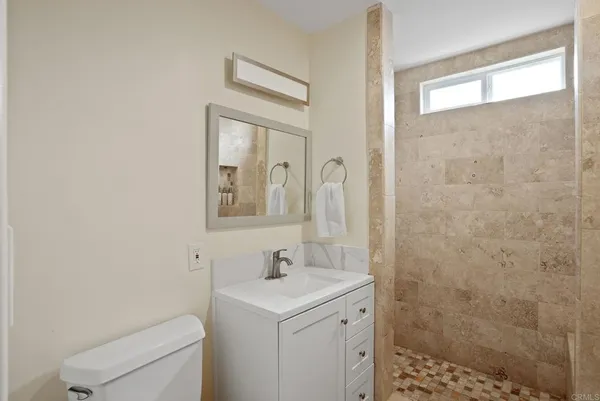 a bathroom with a sink a toilet and a mirror