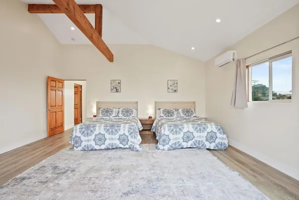 a bedroom with two beds and painted walls