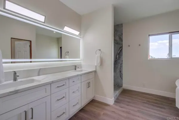 a bathroom with a granite countertop sink mirror and toilet