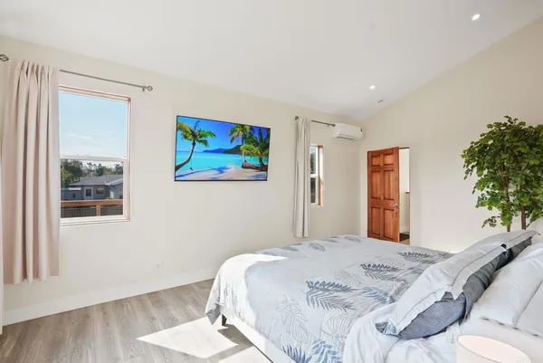 a bedroom with a bed and a painting on the wall