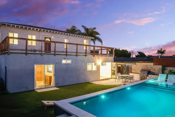 a view of a swimming pool with an outdoor seating and kitchen