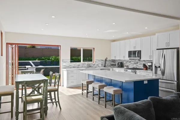 a kitchen with stainless steel appliances kitchen island granite countertop a sink and cabinets