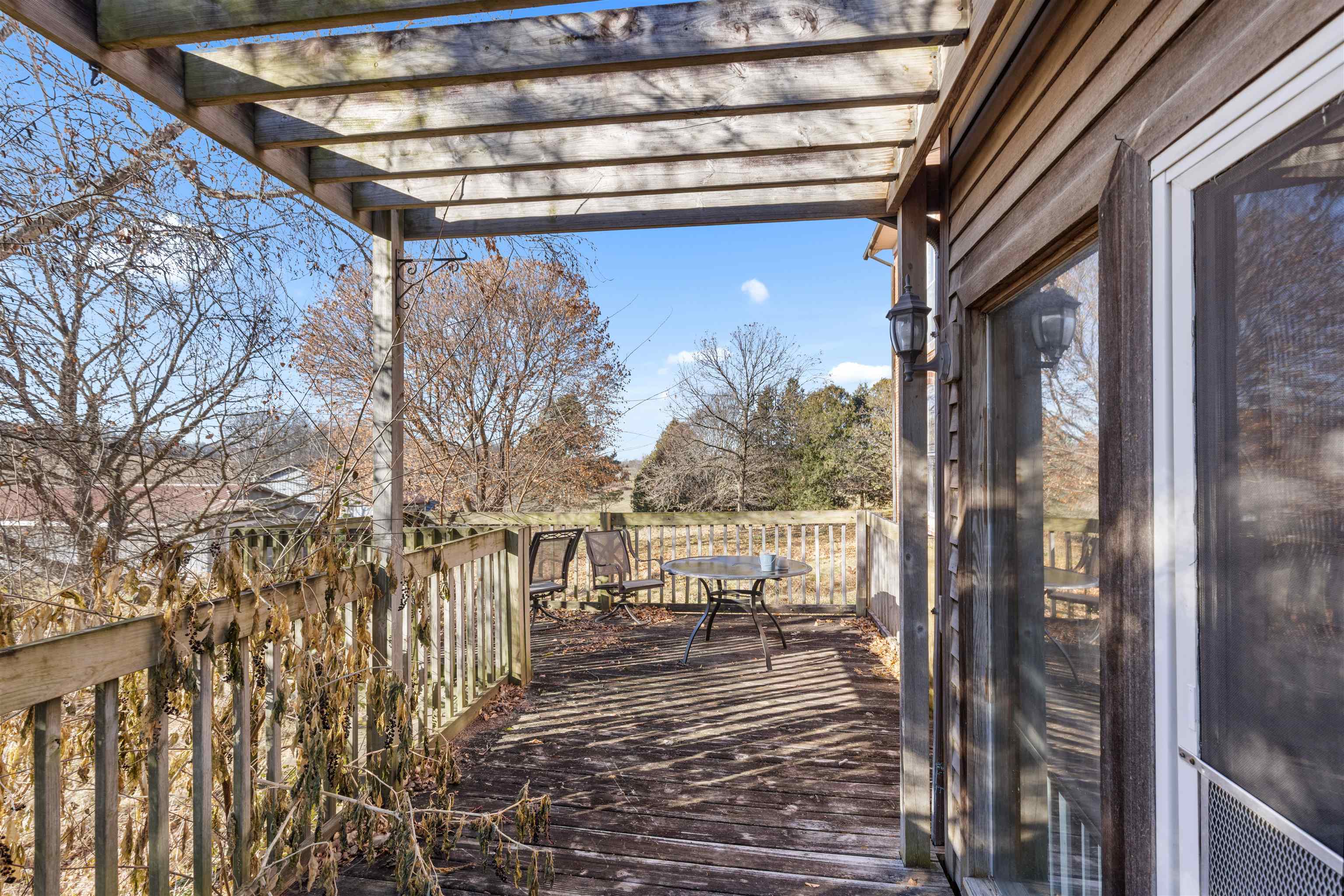 395 North Cedarville Road Freeport, IL 61032 - Photo 15 of 47 a view of balcony with couch and wooden floor