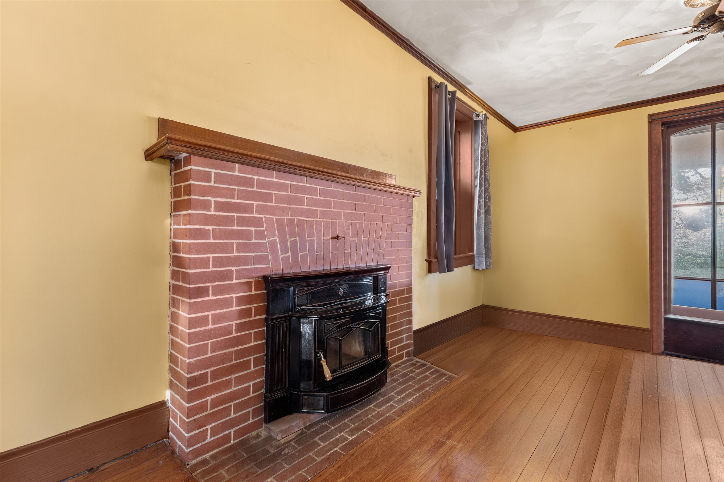 395 North Cedarville Road Freeport, IL 61032 - Photo 4 of 47 a view of an empty room with wooden floor fireplace and a window
