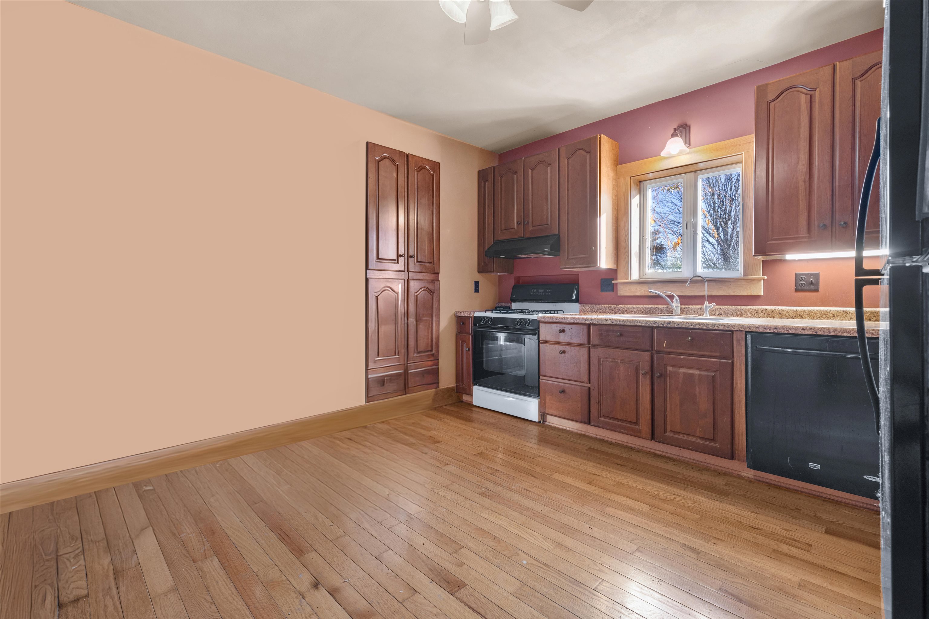 395 North Cedarville Road Freeport, IL 61032 - Photo 5 of 47 a kitchen with stainless steel appliances granite countertop a stove a sink dishwasher and a refrigerator with wooden floor